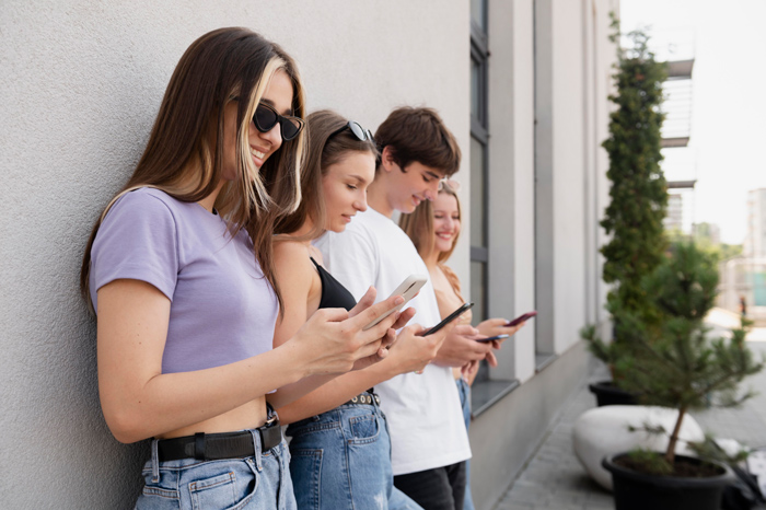 Jovens da geração Z utilizando celular, umas das características dessa geração.